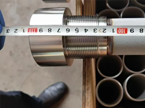 Measure the length of an asymmetric metal membrane filter element with a tape.