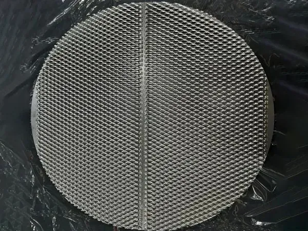 A piece of circular nickel knitted mesh on a black plastic bag