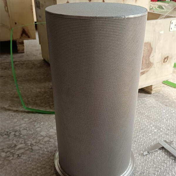 Sintered mesh filter cartridge placed on plant floor with a view of outside opening